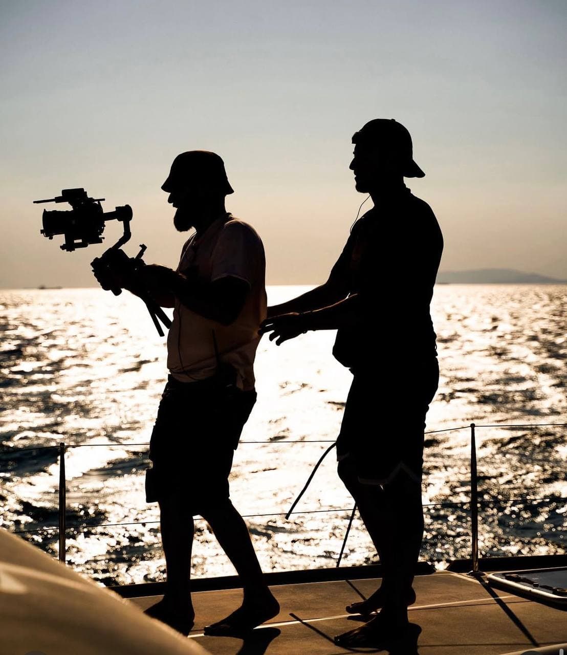 Sunset silhouette filming on boat